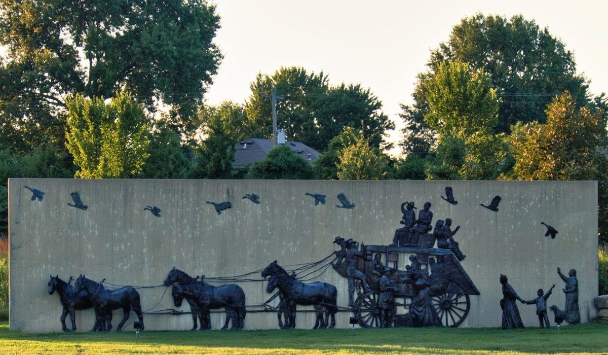 Olathe, Kansas - August, 18 2022 - Old time settlers statue - covered wagon like Oregon Trail video game